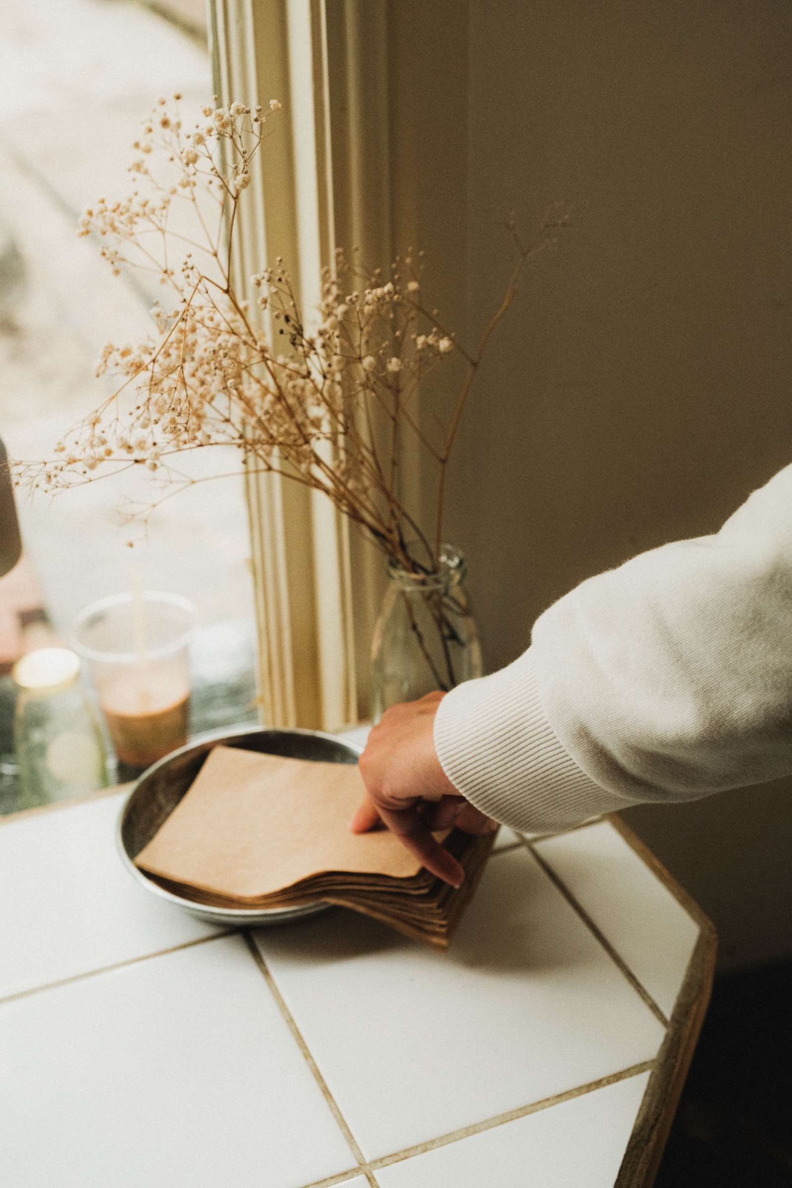Brown paper napkins used in a warm cafe service setting